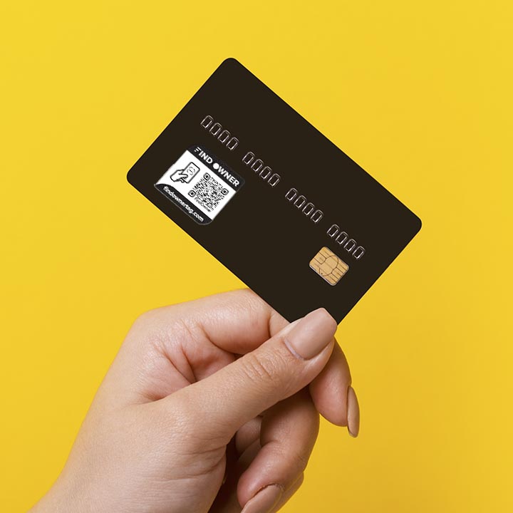 Female hand holding credit card on yellow background